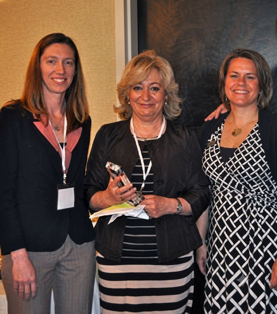 Elizabeth Powell receiving an award alongside colleagues
