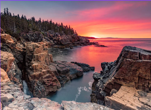 Maine coastline at sunset with rocky cliffs